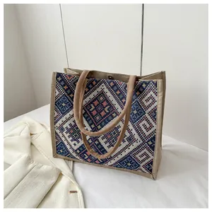 Detail of bohemian tote bag showing geometric patterns and woven rope handles