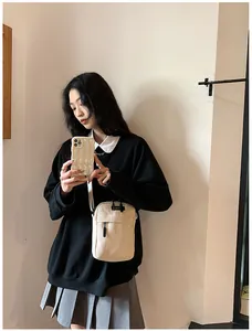 Detailed texture of corduroy fabric on a cream-white crossbody bag for women