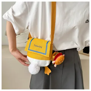 Detail of cute duck canvas crossbody bag with plush tail and hamburger charm accessory