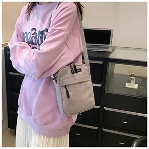Detail of soft corduroy fabric and functional zipper pocket on casual crossbody bag