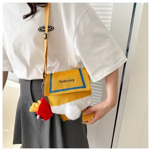 Detail of cute duck canvas crossbody bag featuring fuzzy feet and fries plush charm