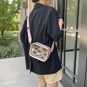 Summer transparent jelly crossbody bag with pink trim and wide strap on female model