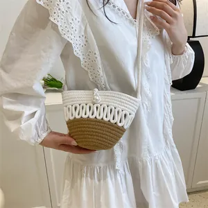 Handwoven pearl straw bucket bag with contrast stitching for summer beach vacations