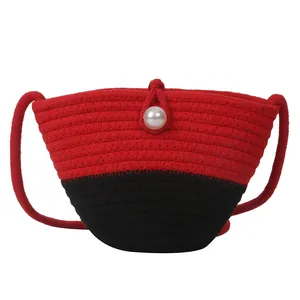 Handmade woven straw beach bag in red and black with pearl button and shoulder strap