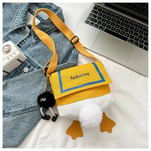 Detailed view of cartoon duck canvas bag featuring plush tail and yellow webbed feet