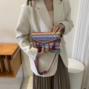 Bohemian hand-woven crossbody bag with colorful tassels and geometric ethnic wide strap