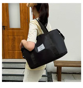 Detailed view of black waterproof fitness bag featuring a separate shoe compartment base