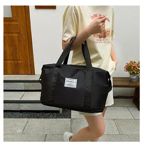 Detailed view of black waterproof fitness travel bag with Fashion tag and dual handles