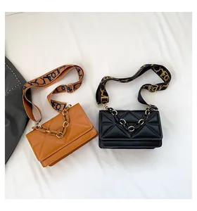 Detail of cross-body bags with geometric quilted texture and acrylic chain handles