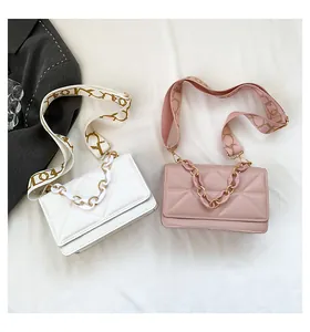 Detail of quilted texture flap bags with acrylic chains and wide patterned straps