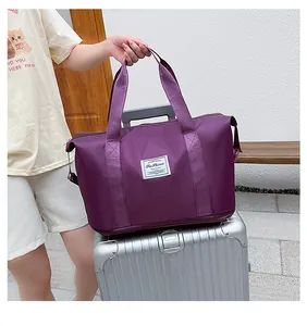 Detail of waterproof purple travel bag with wide straps and expandable zipper base