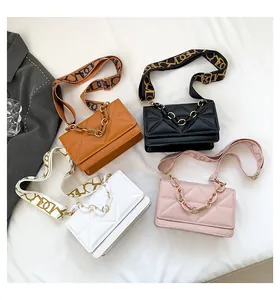 Detail of trendy crossbody bags featuring geometric quilting and stylish acrylic chains