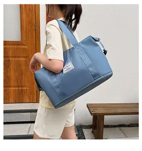 Blue waterproof fitness travel bag with shoulder strap and large storage capacity