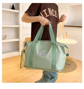 Close-up of a large capacity waterproof light green travel bag with wide carry handles