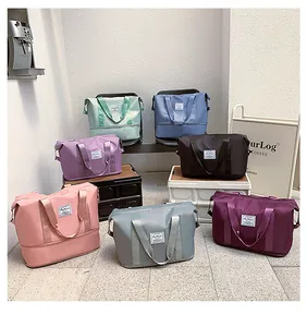 Collection of colorful waterproof travel bags showing durable nylon material and handles