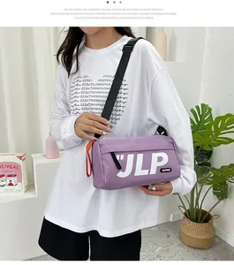 Detail of purple nylon messenger bag with JLP logo and adjustable black shoulder strap