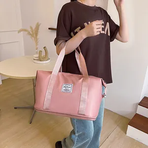 Pink large capacity travel bag with waterproof material and bottom storage compartment