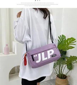 Purple cylindrical nylon messenger bag with white JLP lettering on adjustable shoulder strap
