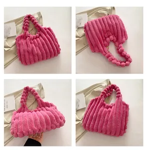 Detail of rose pink plush tote bag with thick vertical stripes and fuzzy ball handle