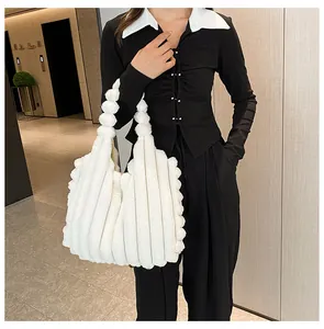 Detail of white plush tote bag showing soft faux fur texture and bubble style handle