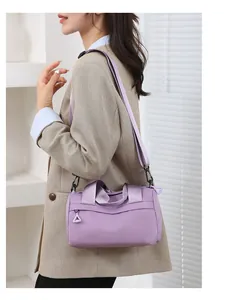 Borsa multifunzionale in nylon viola su modella con blazer a quadri per stile casual