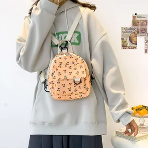 Mini orange corduroy backpack with cherry print and adjustable cream straps