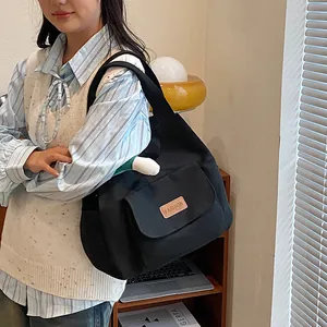 Black canvas tote bag for women with fashion patch and shoulder strap, casual style