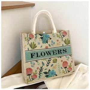 Detail of floral linen tote bag with FLOWERS embroidery and metal magnetic buckle