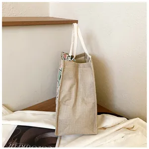 Side view of spacious linen tote bag with sturdy handles and vintage embroidery details
