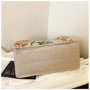 Detailed texture of rustic linen tote bag with vibrant floral embroidery and natural weave