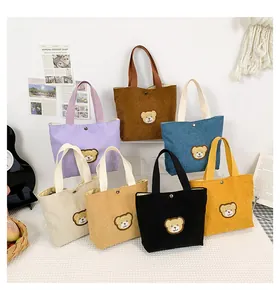 Mini corduroy tote bags in seven colors featuring cute bear embroidery and snap button detail