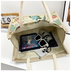 Top view of embroidered linen tote bag showing spacious interior with daily essentials