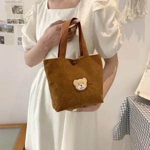 Cute brown corduroy handbag featuring a small bear embroidery and soft tote handles