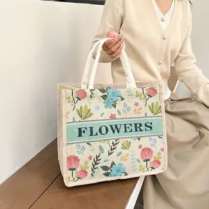 Vintage embroidered linen tote bag with floral patterns and FLOWERS lettering detail