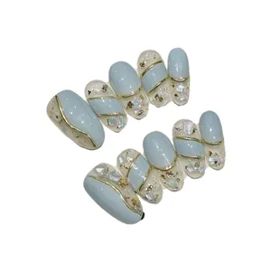Handmade press-on nails in mint blue and gold edge design with aurora glitter