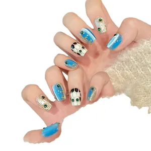 Handmade sapphire blue cat-eye press-on nails with champagne gold and rhinestone accents