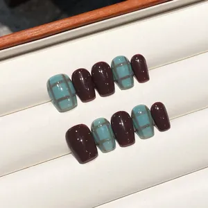 Handmade press-on nails in chocolate brown and blue plaid pattern with glossy finish