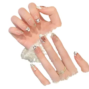 Handmade press-on nails with maple leaf art, French tips, and gold foil accents