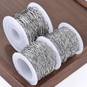 Three rolls of stainless steel flat oval cable chains for DIY jewelry making on wood tray