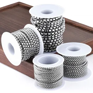 Detailed view of silver stainless steel jewelry chains on spools for DIY accessory crafting