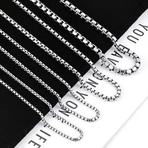 Detail view of five different widths of polished stainless steel box chains on black velvet