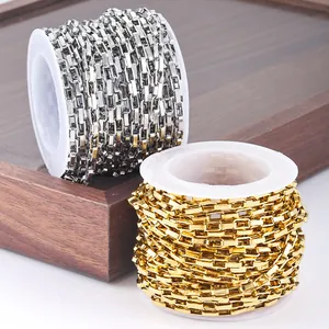 Detailed view of gold and silver stainless steel box chains on white plastic spools for DIY