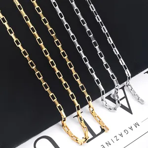 Polished gold and silver stainless steel paperclip chain links on black velvet