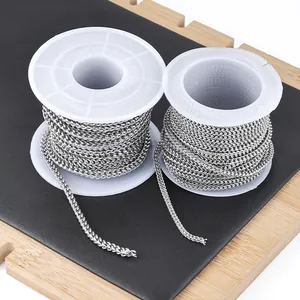 Detailed view of silver stainless steel wheat chains wound on white plastic spools