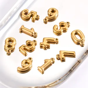 Detailed macro shot of 3D gold stainless steel number charms for DIY jewelry making