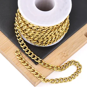 Detail of bulk gold-plated stainless steel Cuban link chain on a white plastic spool