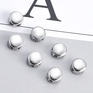 Close-up of polished stainless steel beads with double holes for DIY jewelry making