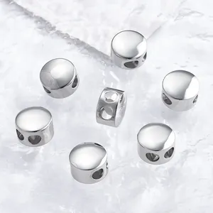 Close-up of polished stainless steel spacer beads with multiple holes for DIY jewelry