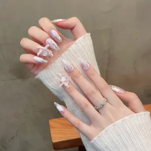 Handmade cat-eye press-on nails with 3D pink bows, white floral art and silver glitter