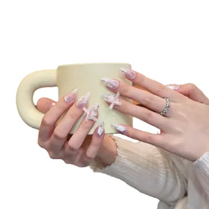 Handmade almond nails with 3D pink bows, white floral accents, and silver glitter finish